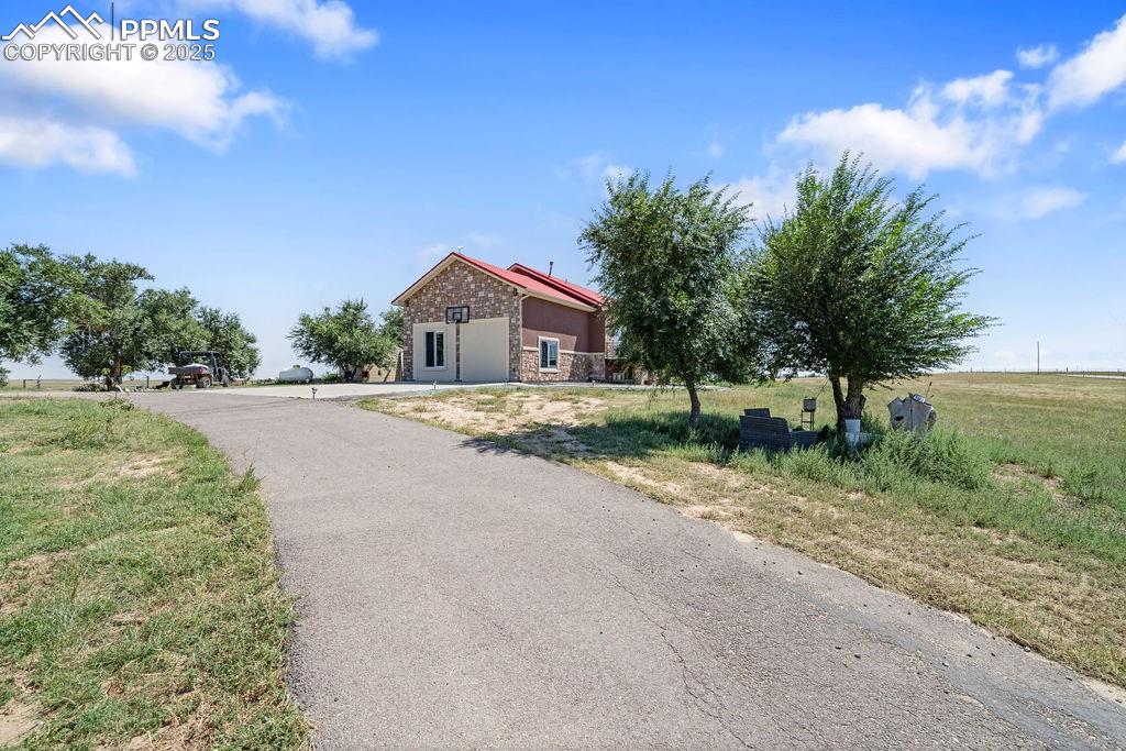 Image 3 of 50: View of front of home featuring stone siding and a view of countryside