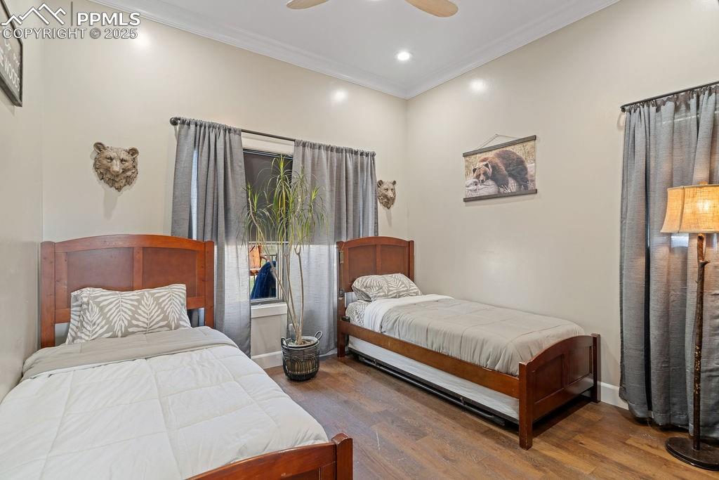 Image 33 of 50: Bedroom featuring ornamental molding, wood finished floors, a ceiling fan, 