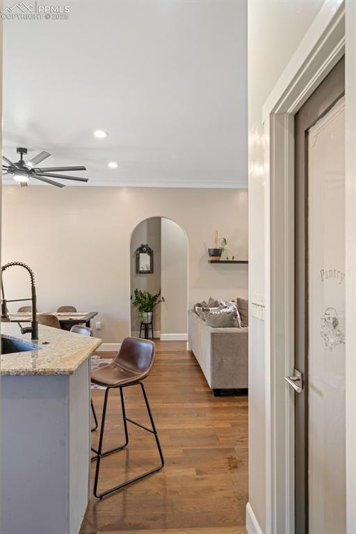 Image 33 of 50: Kitchen featuring arched walkways, dark wood finished floors, recessed ligh