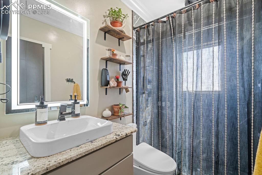 Image 34 of 50: Full bath featuring a shower with curtain, vanity, and crown molding