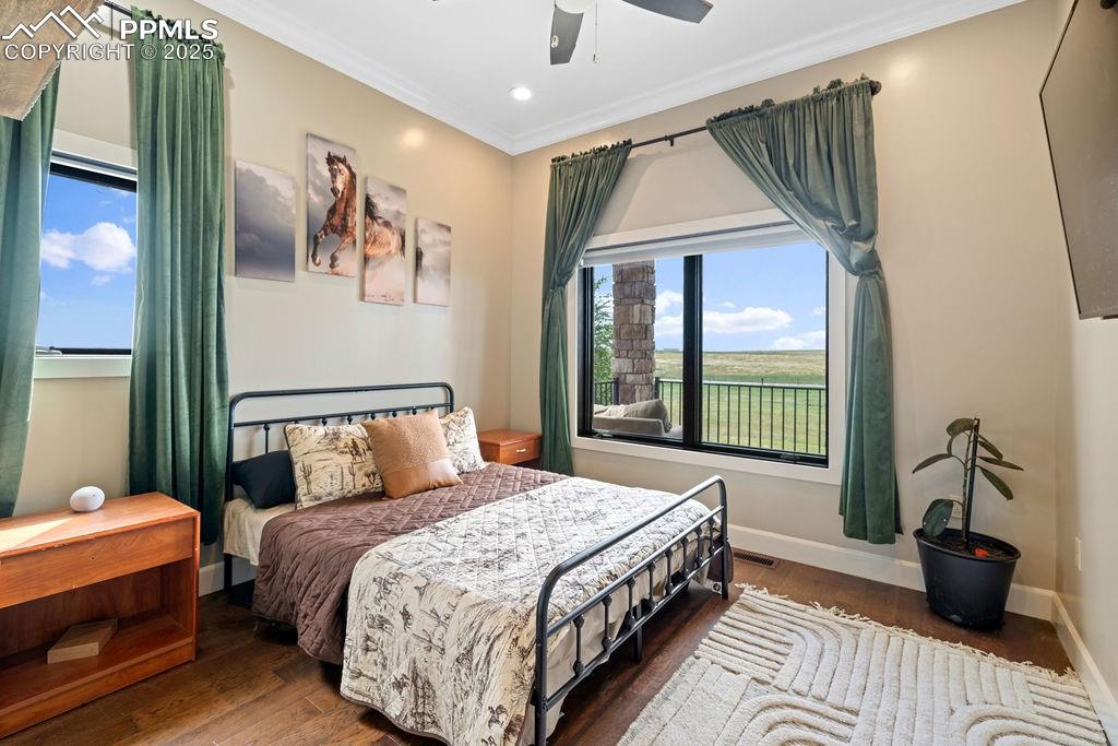 Image 35 of 50: Bedroom featuring wood finished floors, ornamental molding, recessed lighti