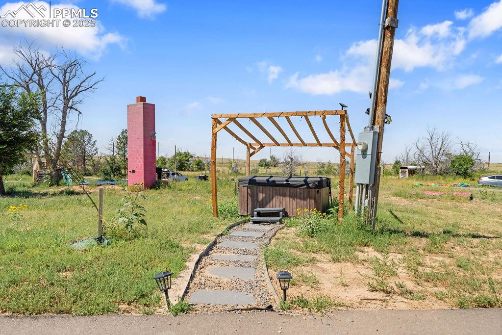 Image 47 of 50: View of yard with a hot tub