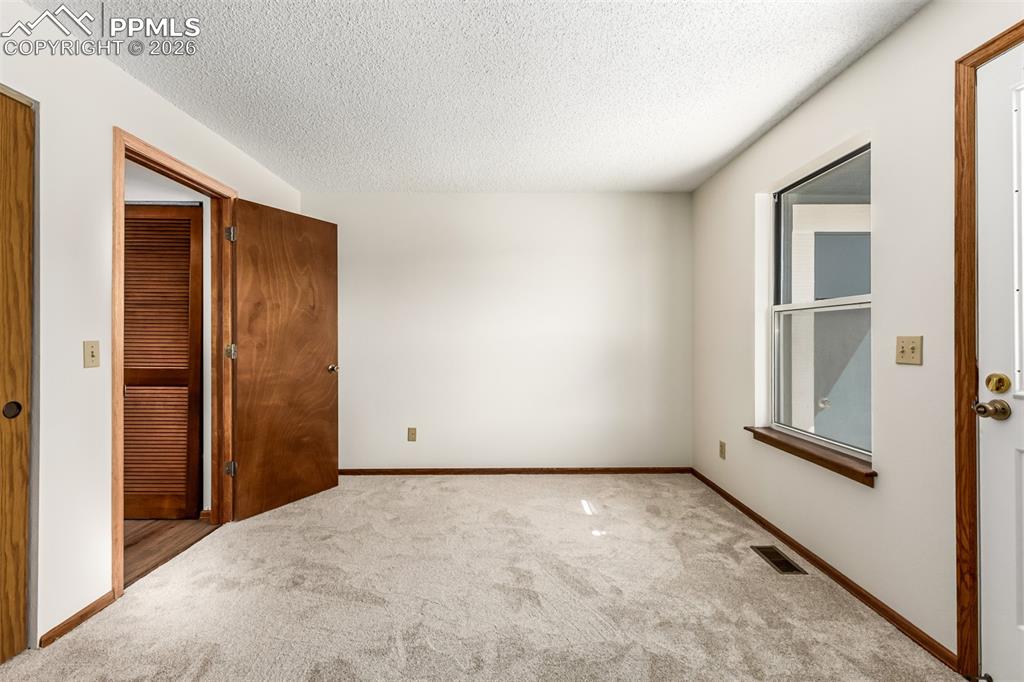 Image 13 of 25: Kitchen features warm wood cabinets, durable countertops, new appliances an