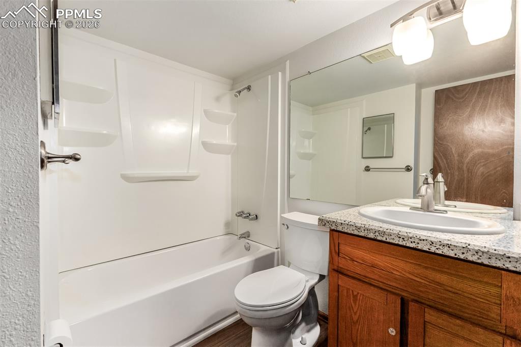 Image 14 of 25: Bright kitchen with plenty of storage and workspace.