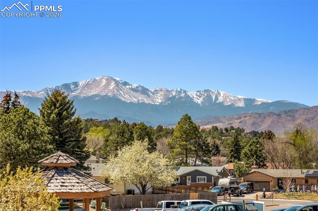Image 18 of 25: Full bathroom with updated vanity, solid surface countertops, and tub/showe
