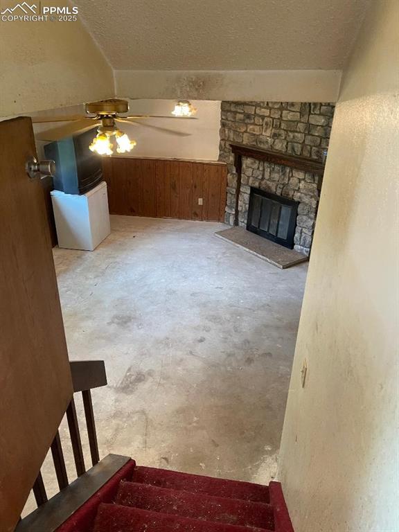 Image 10 of 11: FAMILY ROOM WITH FIREPLACE. TWO FANS