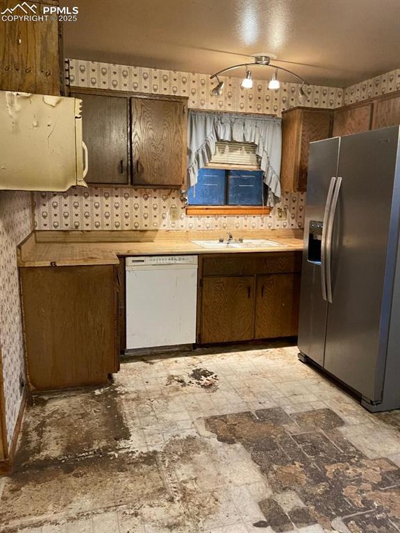 Image 8 of 11: KITCHEN WITH NICE REFRIGERATOR AND NOTE FAN