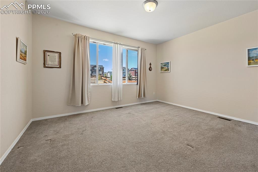 Image 11 of 37: The ground-level master suite is ready for your king or queen-sized bed and