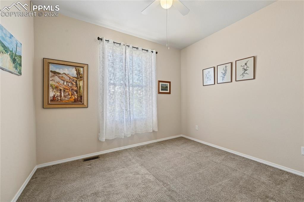 Image 15 of 37: Bedroom #2 of 4 is on the main level, right around the corner from another 