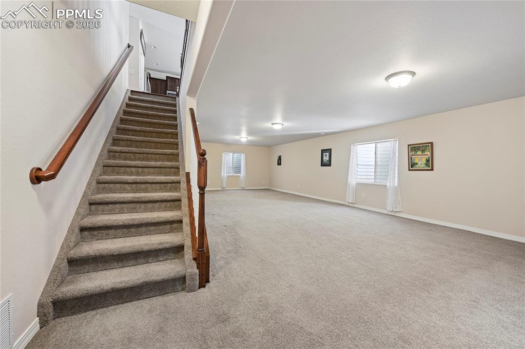 Image 19 of 37: From the heart of the home your stairs to the basement lead to a ginormous 