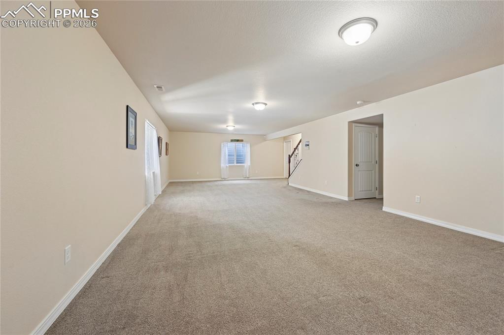 Image 21 of 37: This 37-foot long downstairs family room could handle a pool table, ping-po
