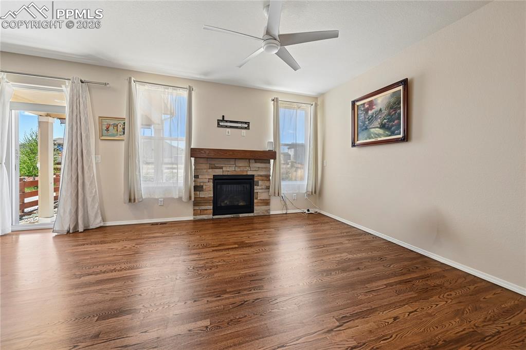 Image 5 of 37: The living room is warmed with both the flame and appeal of a stacked stone