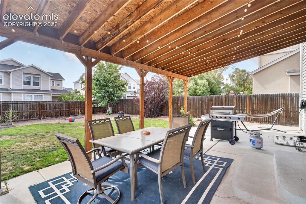 Image 18 of 30: Covered 30x16 patio with built-in awning