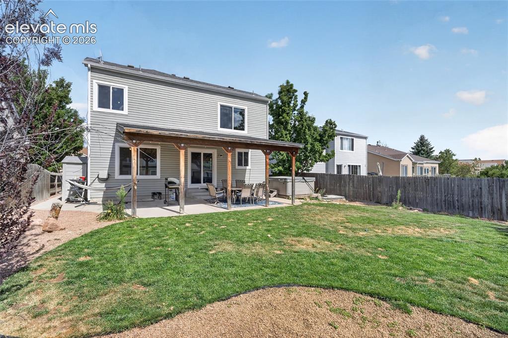 Image 22 of 30: Backyard and rear elevation