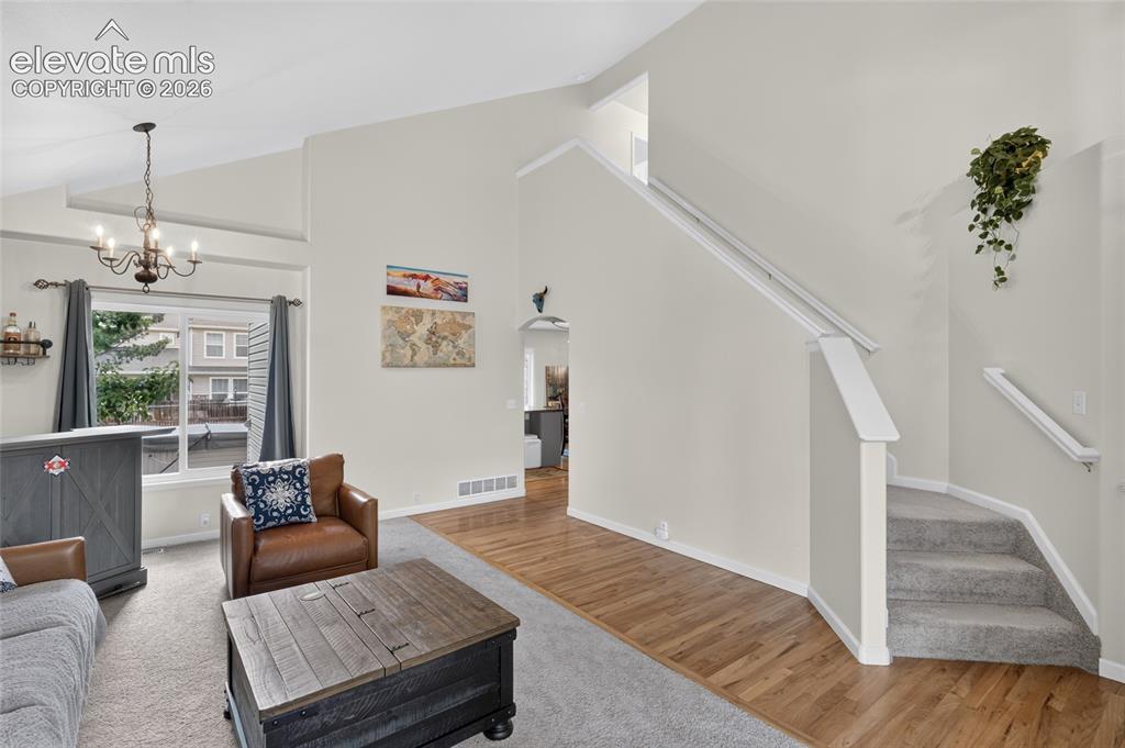 Image 4 of 30: Vaulted living room and staircase