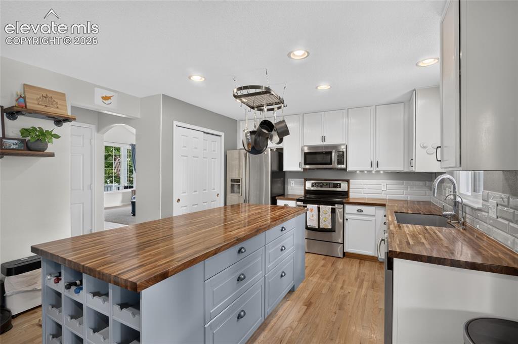 Image 7 of 30: Kitchen island with built-in wine rack