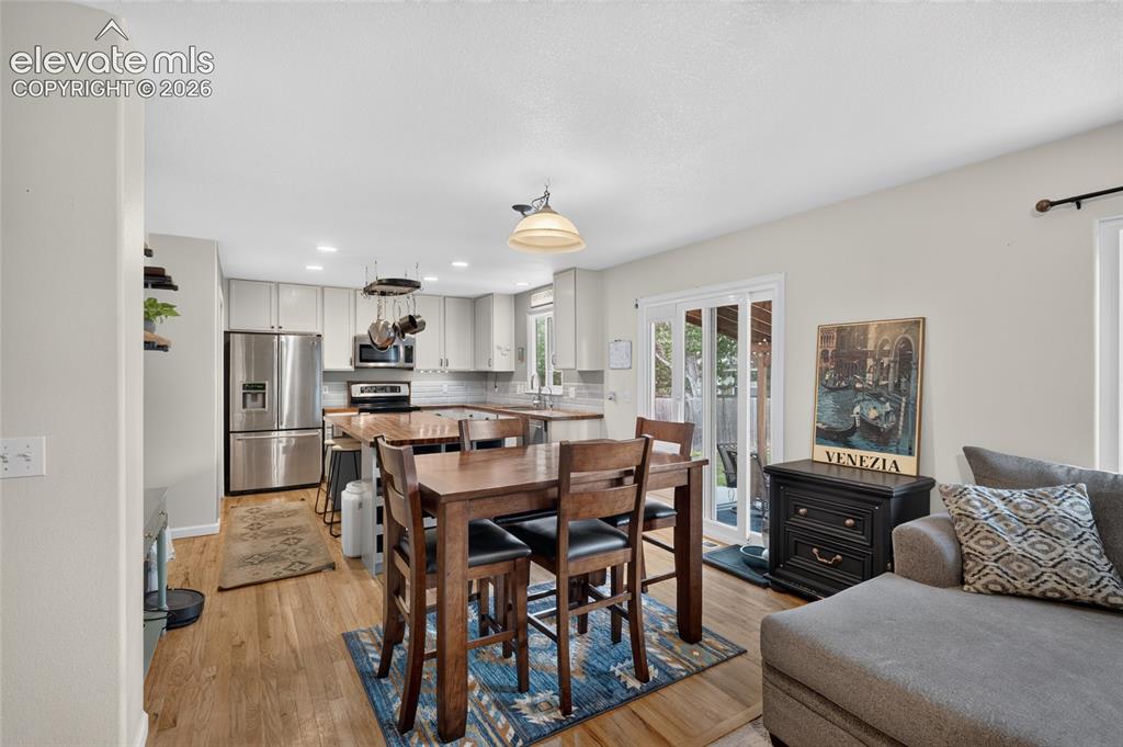 Image 9 of 30: Dining area open to kitchen and patio