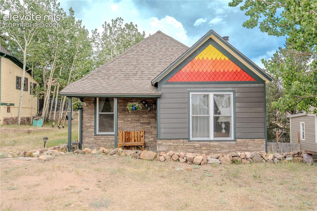 Image 1 of 40: Exterior featuring a gabled roof, stone veneer siding, horizontal lap sidin