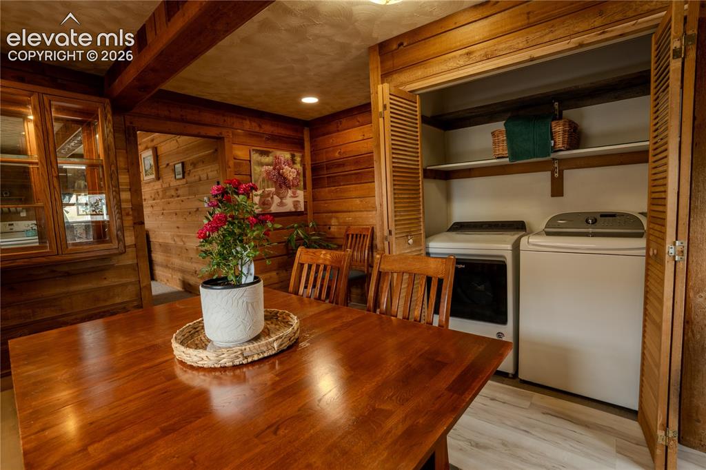 Image 16 of 40: Dedicated laundry closet with louvered bifold doors, integrated shelving, a