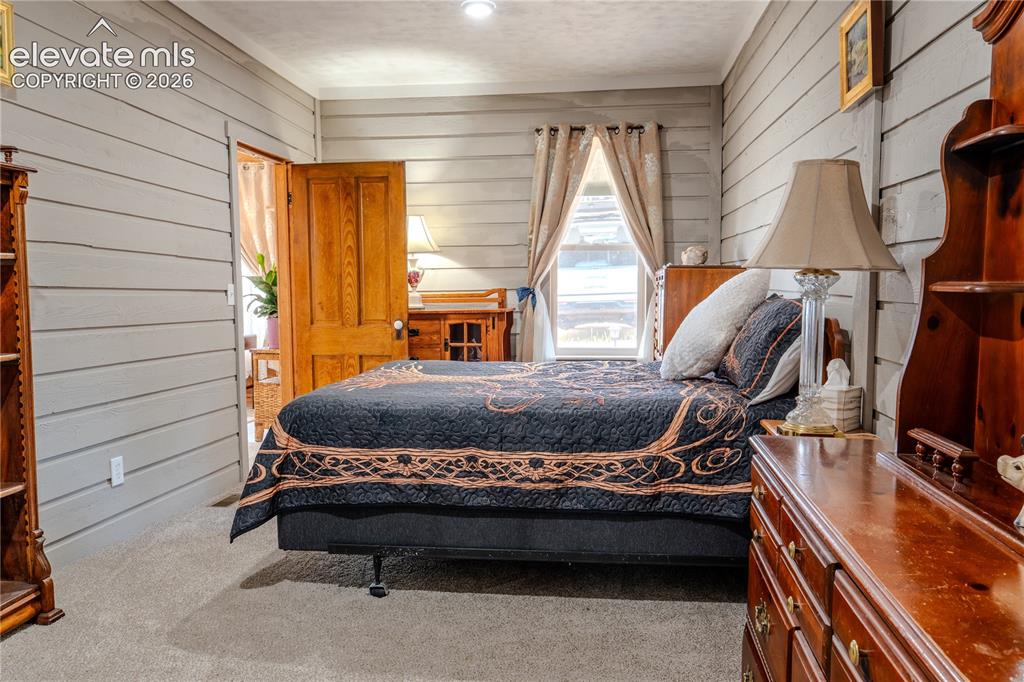 Image 22 of 40: Horizontal plank wall paneling with a natural wood doorframe and light wood