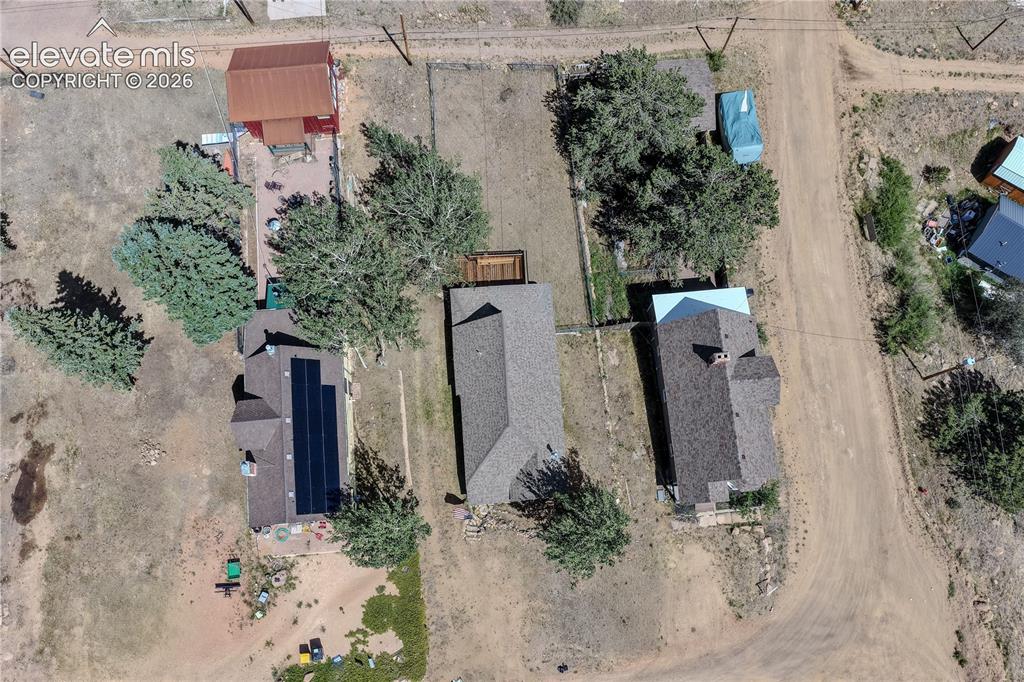 Image 39 of 40: Aerial perspective highlighting a property with a gabled roof, solar panel