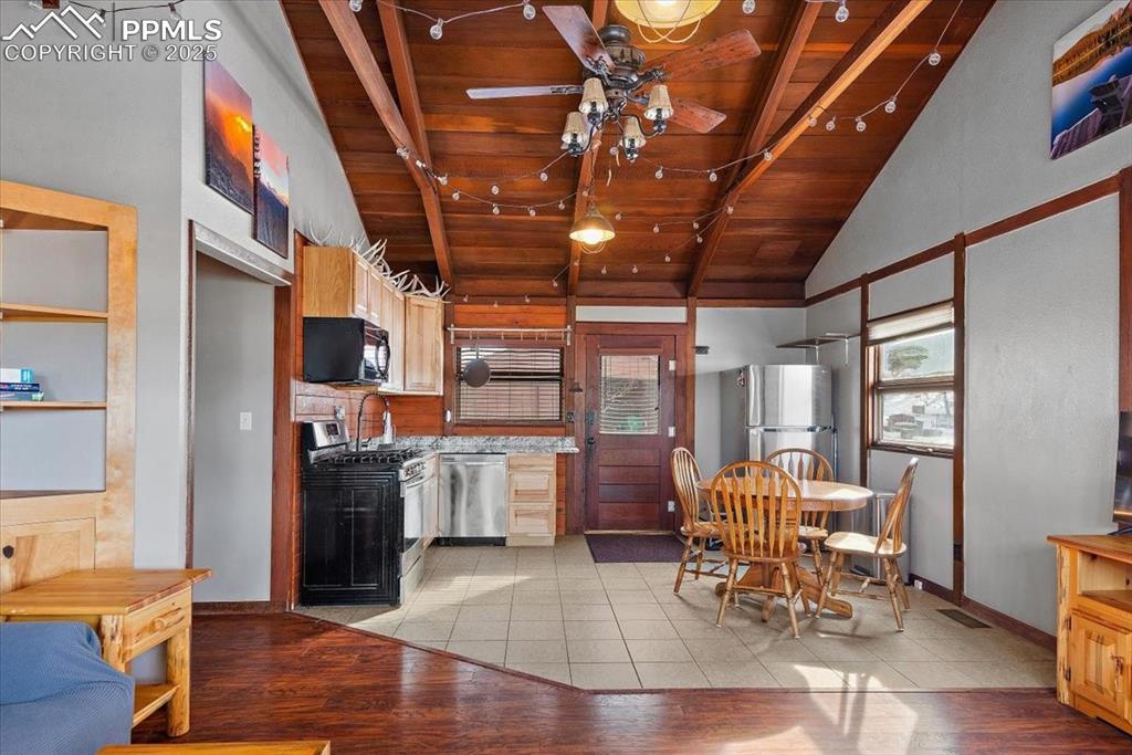 Image 5 of 25: Kitchen with baseboards, a ceiling fan, wooden ceiling, light wood-style fl