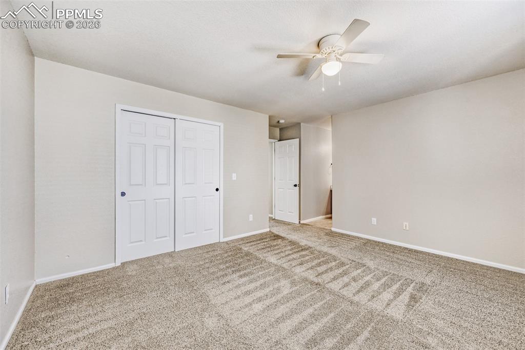 Image 13 of 28: Primary suit with ceiling fan and bay window. Central AC newly installed.