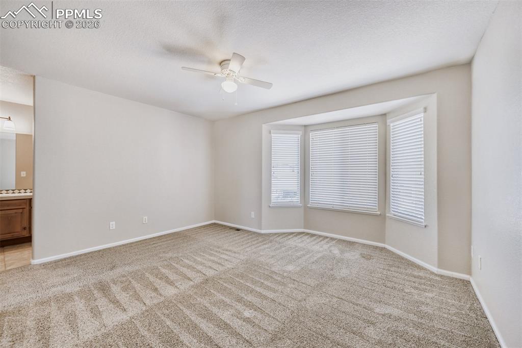 Image 14 of 28: Primary suite with adjoining bathroom.