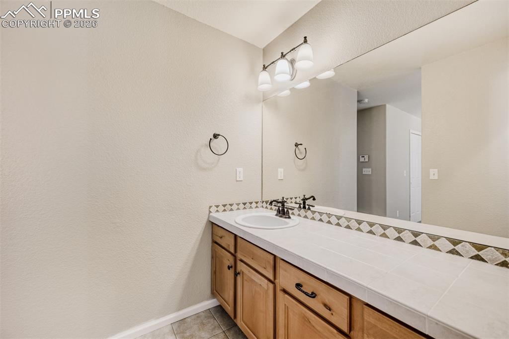 Image 16 of 28: Bathroom featuring vanity, shower / bath combination, light tile patterned