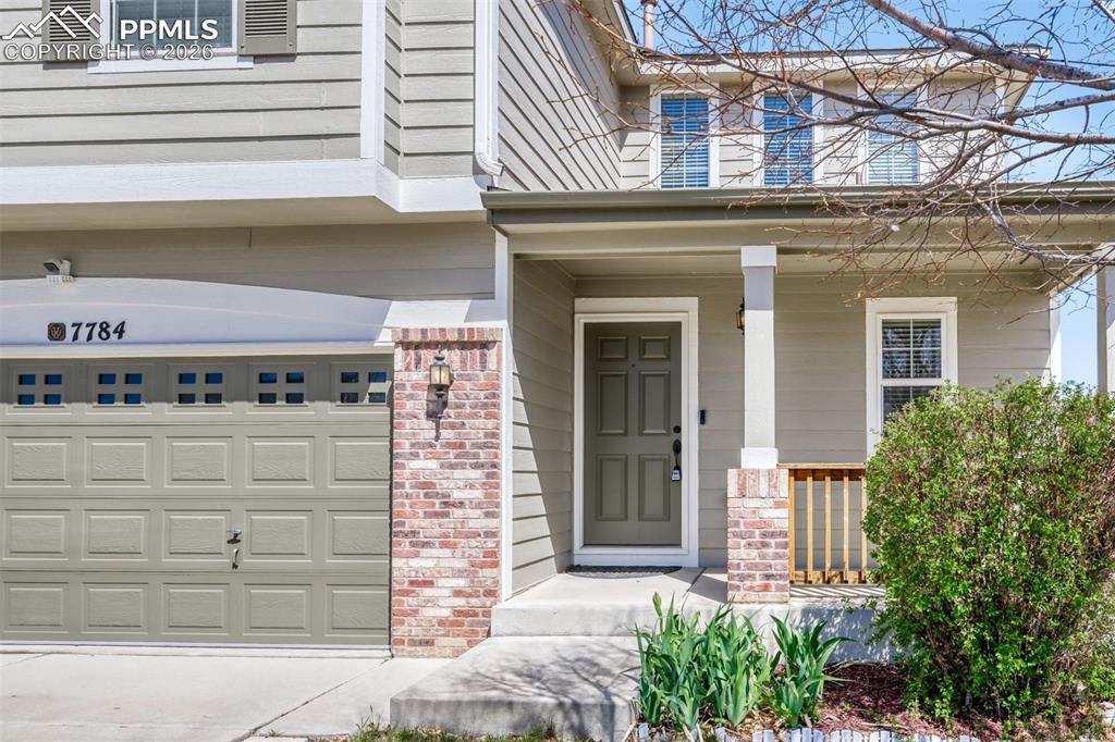 Image 2 of 28: Craftsman-style home on corner lot with covered porch, brick siding, drivew