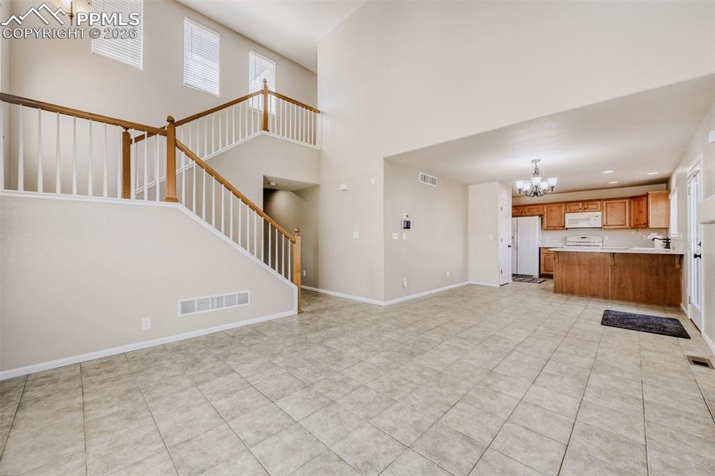 Image 5 of 28: Great room featuring vaulted 2-story ceiling height, built in shelves, a na