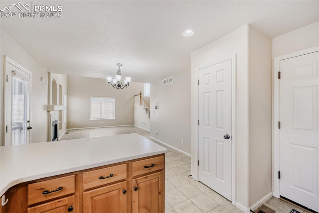 Image 9 of 28: Kitchen with plenty of knotty alder cabinet and storage space.