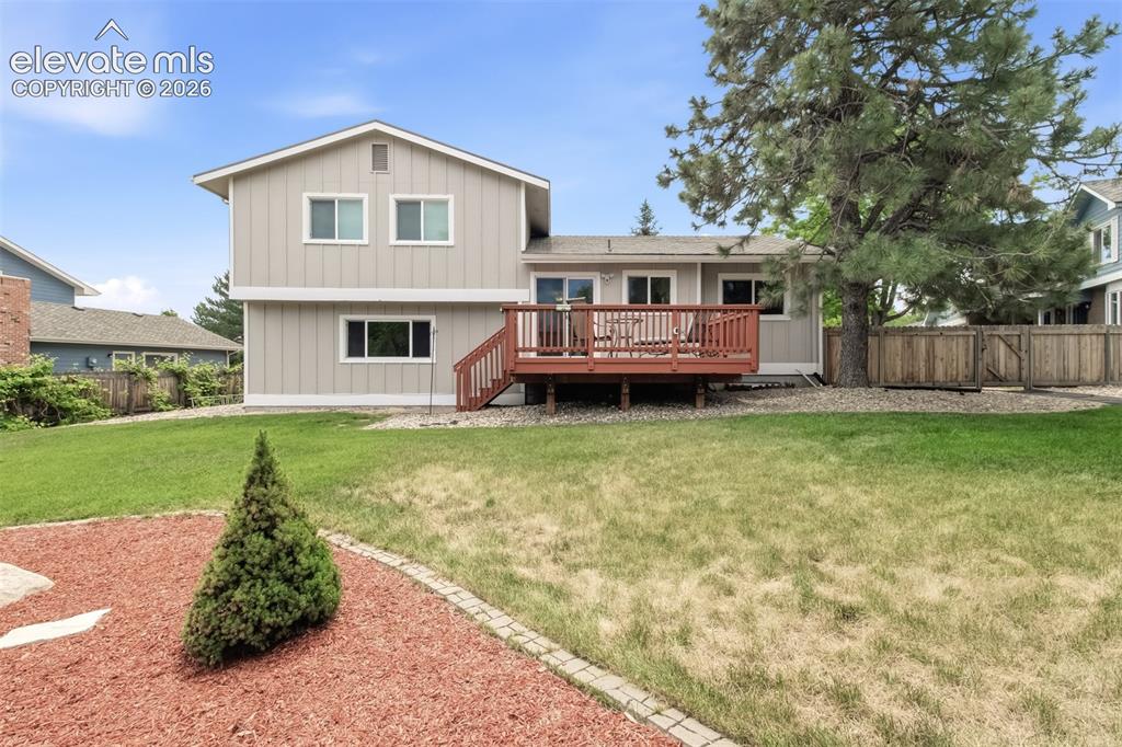 Image 11 of 39: Back view of the home and backyard