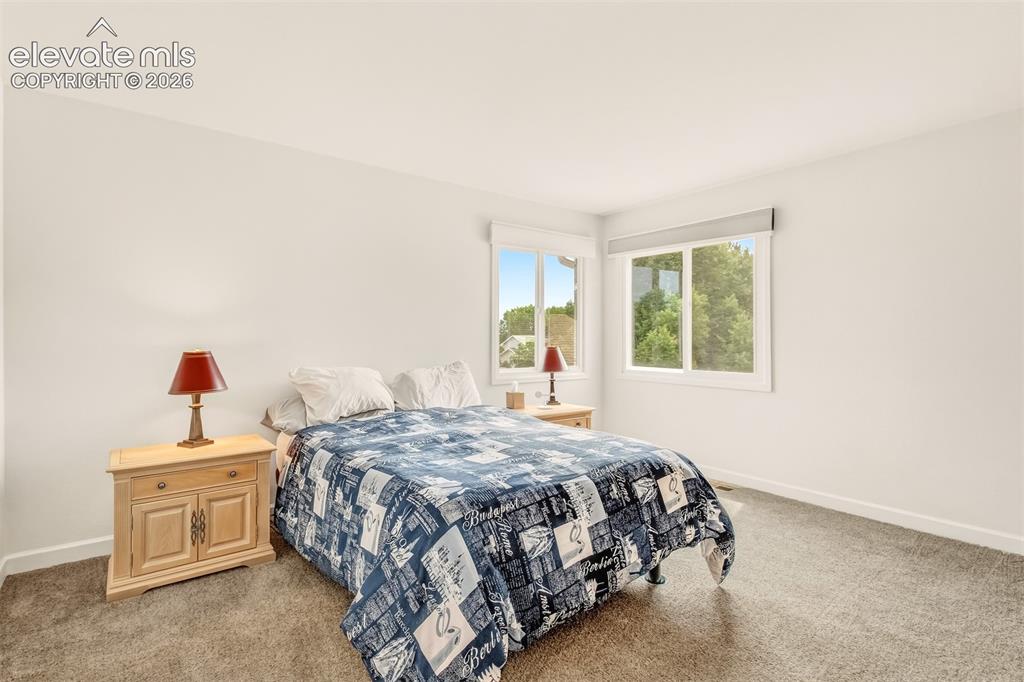 Image 13 of 39: Primary bedroom upper level with walk in 4 piece bathroom and walk in close