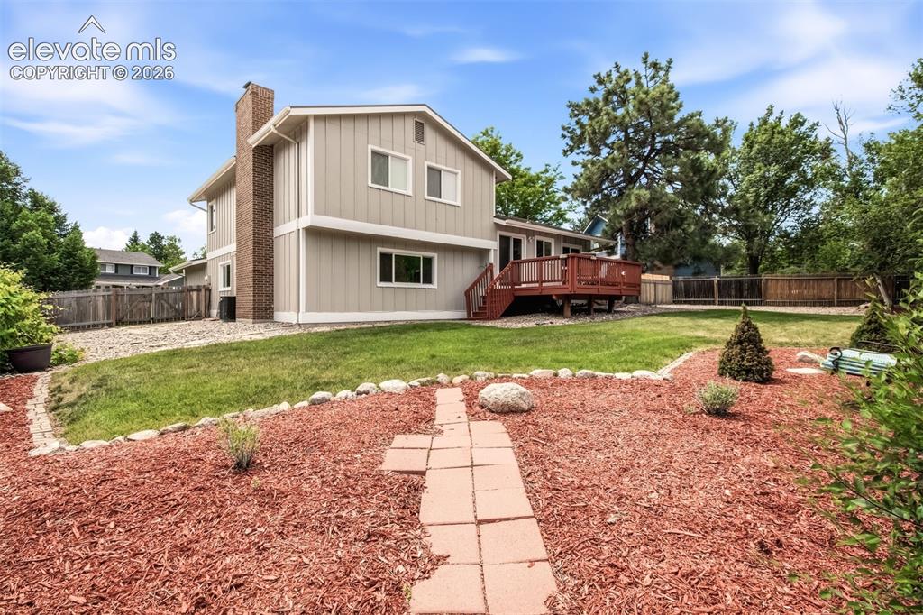 Image 36 of 39: Back view of the home and backyard