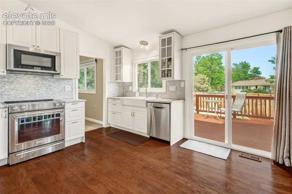Image 8 of 39: Kitchen with quartz countertops, matching stainless steel appliances and a