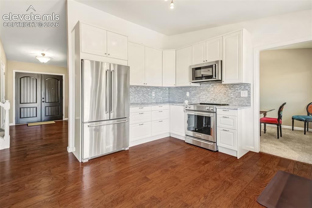 Image 9 of 39: Kitchen with quartz countertops, matching stainless steel appliances and a