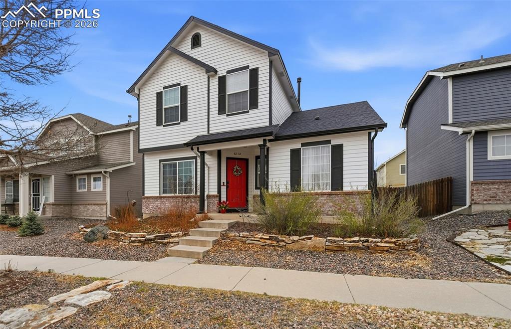 Image 1 of 44: Two-story residence featuring white siding, black window shutters, and a di