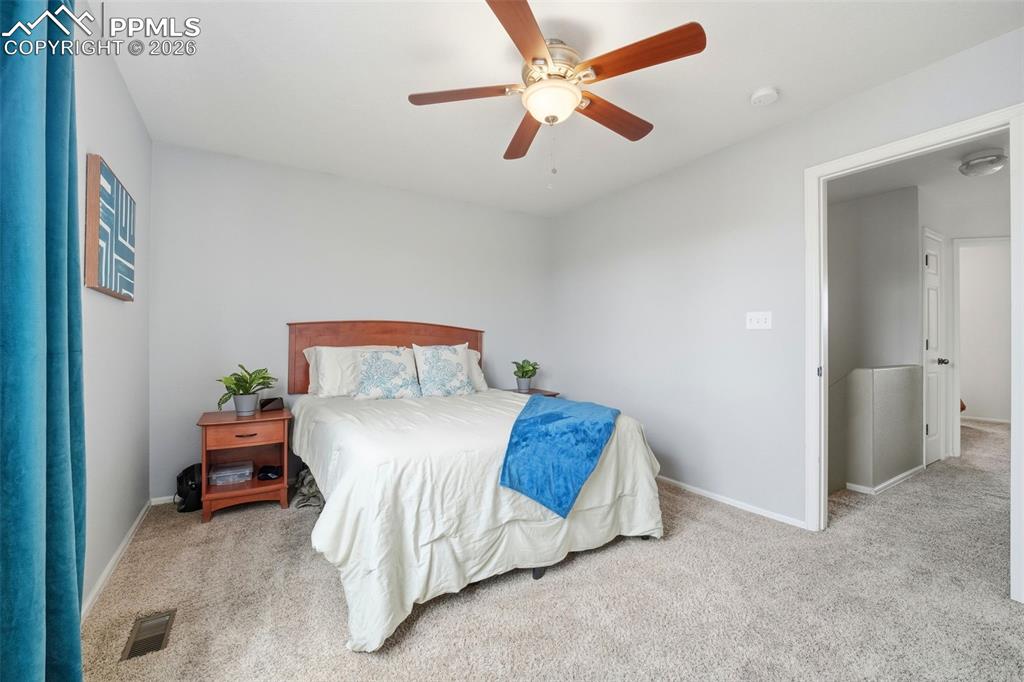 Image 17 of 44: Carpeted room with light gray walls and a ceiling fan with integrated light