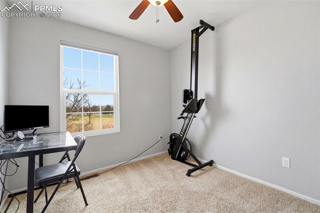 Image 21 of 44: Carpeted room featuring a white-framed window, a ceiling fan with wood-fini