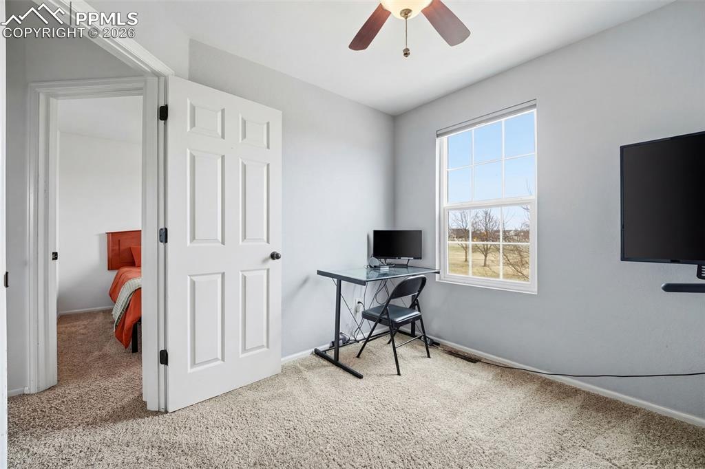 Image 22 of 44: Carpeted room featuring a ceiling fan with integrated lighting, a double-hu