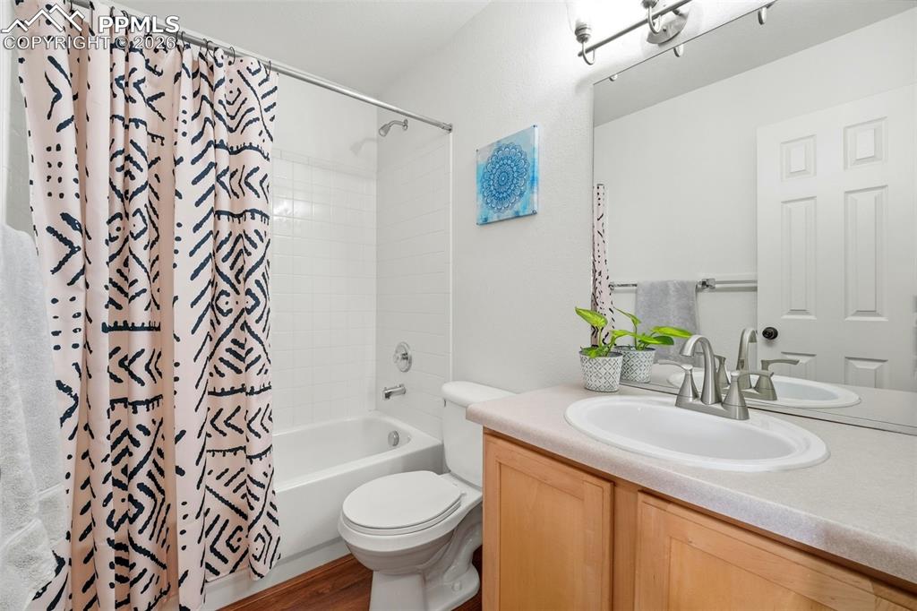 Image 24 of 44: Full bathroom featuring a white tub with shower, white subway tile surround