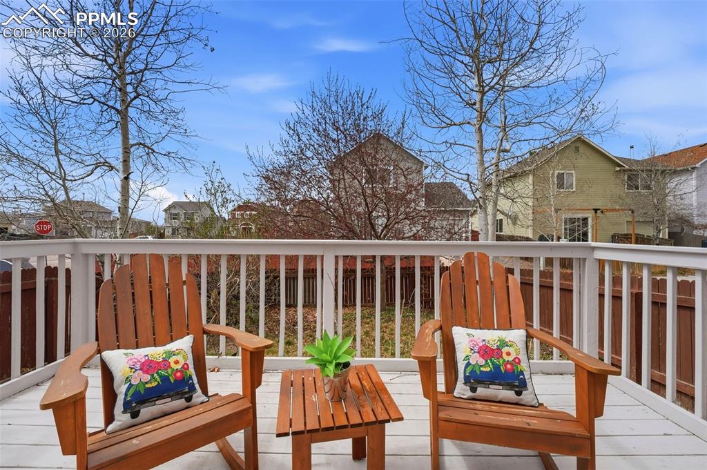 Image 25 of 44: Spacious outdoor deck featuring a white railing and a neutral-toned surface