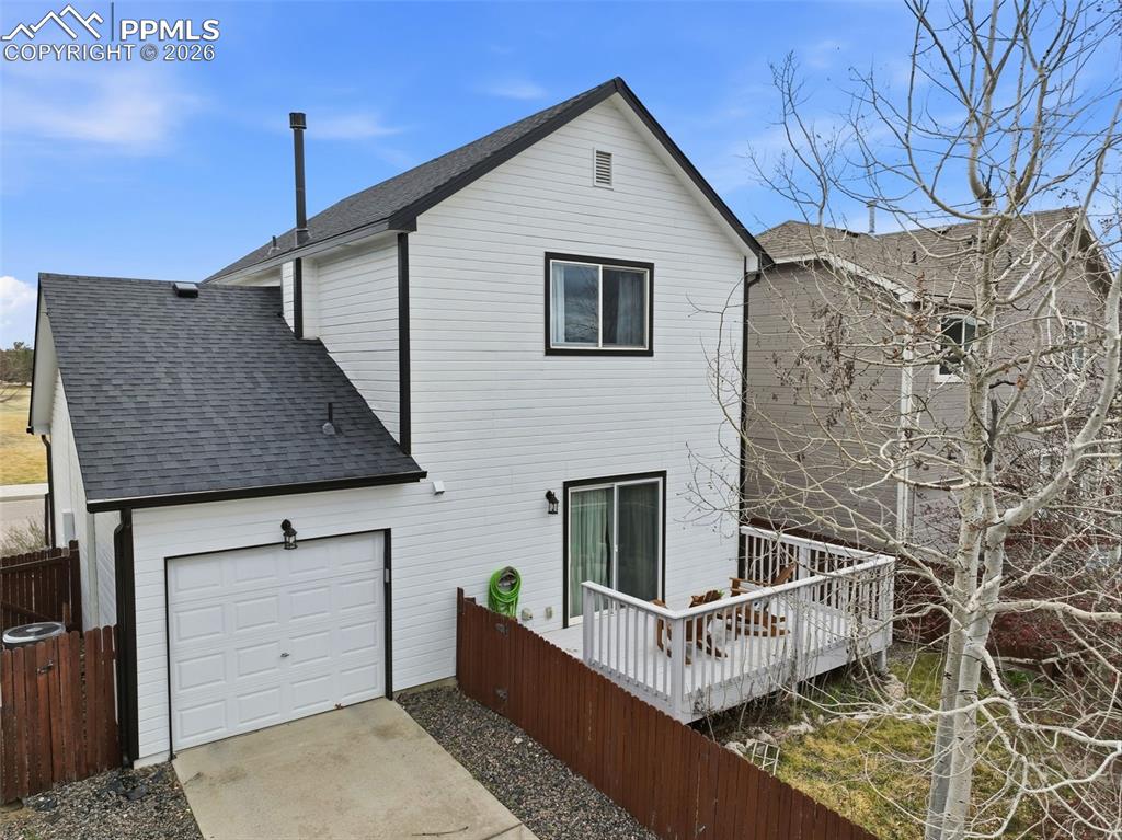 Image 36 of 44: White siding exterior with black trim, featuring a dark asphalt shingle roo