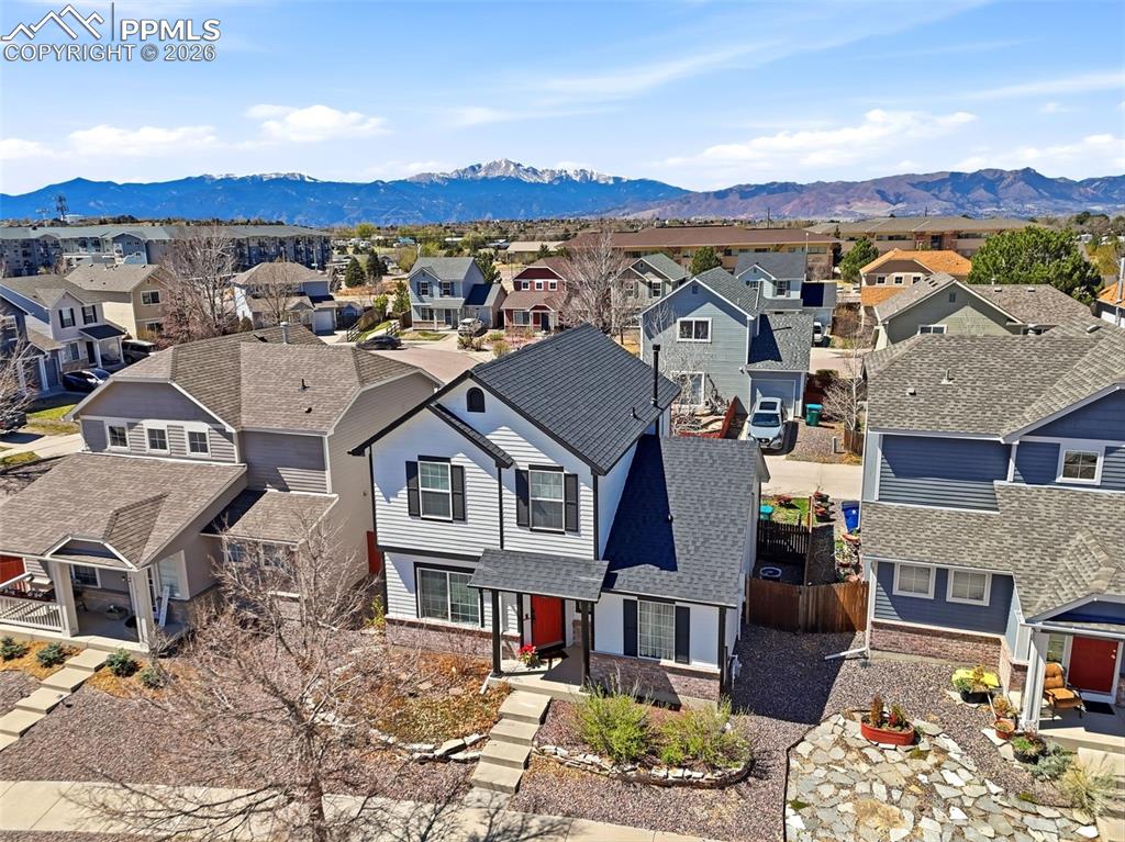Image 39 of 44: Two-story residence featuring white siding with black trim, a dark shingle 