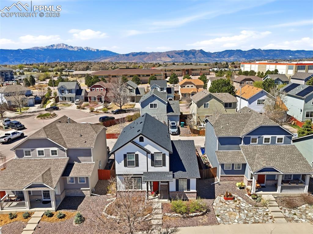 Image 41 of 44: Contemporary residence with white siding and dark trim, featuring a promine