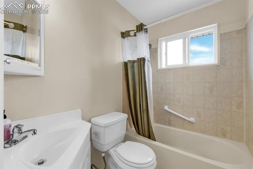 Image 13 of 25: Full bath with vanity and shower / bath combo 