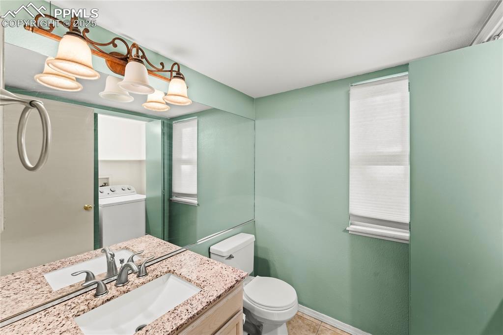 Image 13 of 38: Main level half bath and laundry room