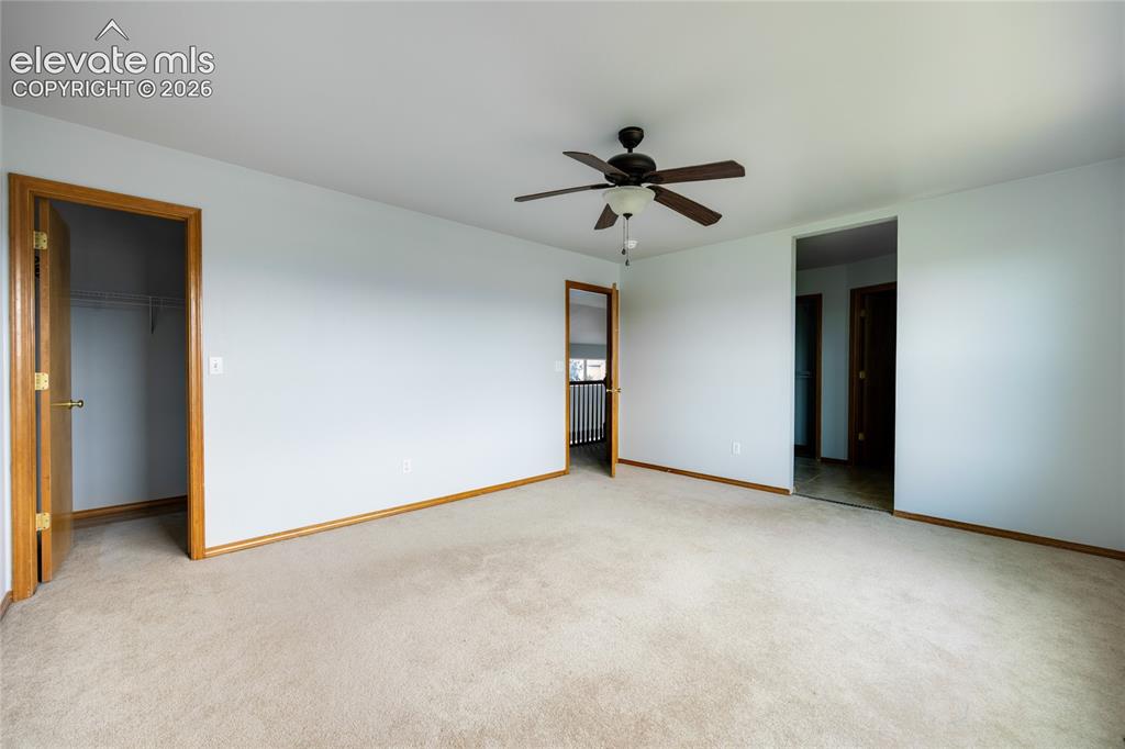 Image 16 of 34: Spacious room featuring carpeting, light-toned walls, and wood trim