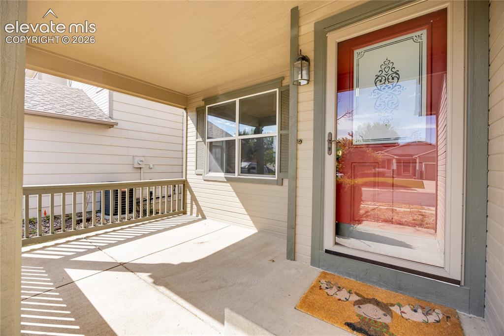 Image 2 of 34: Covered front porch with concrete flooring
